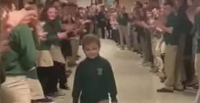 Menino volta à escola após cura de leucemia sob aplausos de alunos