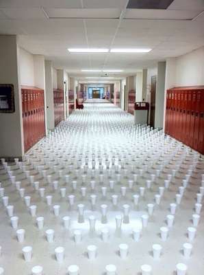 Copos cheios de água para ninguém conseguir passar pelo corredor